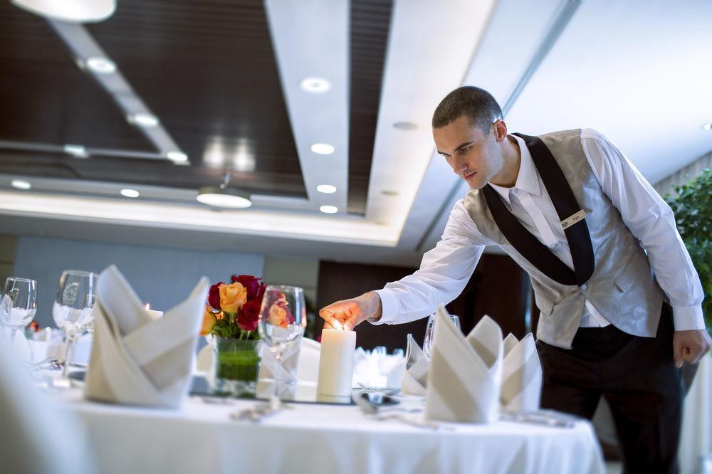 Hyatt Regency Oryx Doha Hotel Exterior photo A waiter lighting a candle